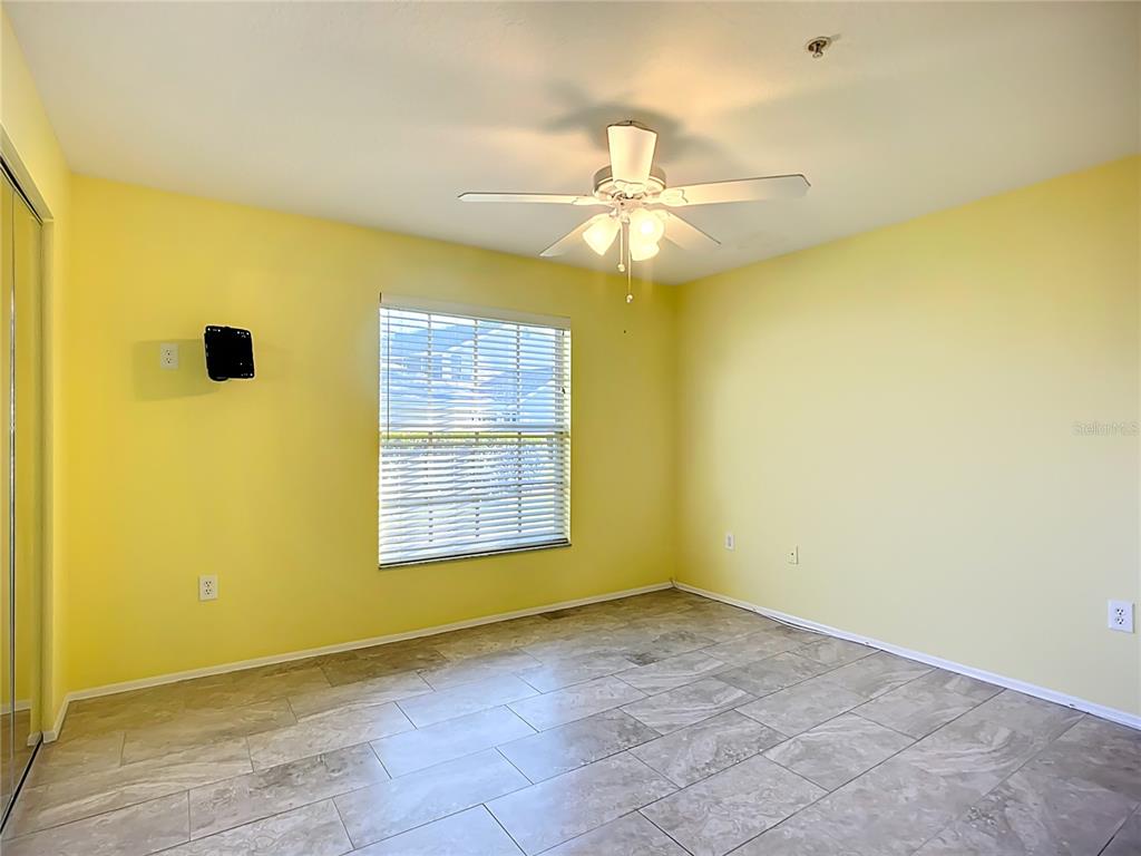 6330 Green Oak Circle, Unit 6330 Bradenton, FL 34203 - Photo 20 of 58 an empty room with a window and a ceiling fan