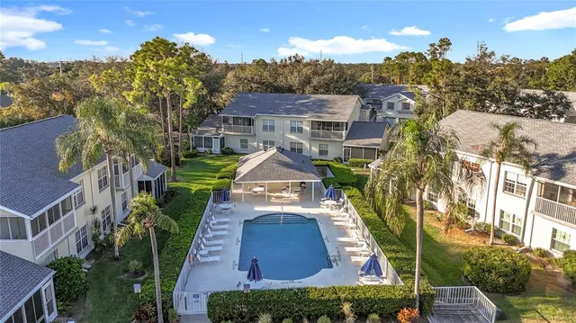 an aerial view of a with swimming pool outdoor seating and yard