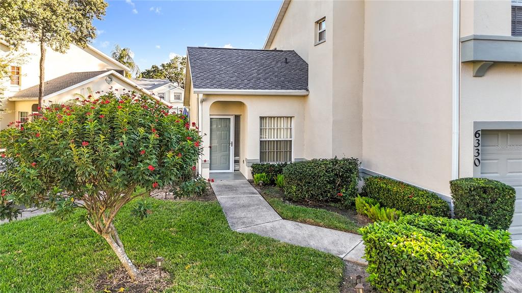 6330 Green Oak Circle, Unit 6330 Bradenton, FL 34203 - Photo 7 of 58 a front view of a house with garden