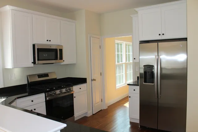 a kitchen with a refrigerator stove and microwave