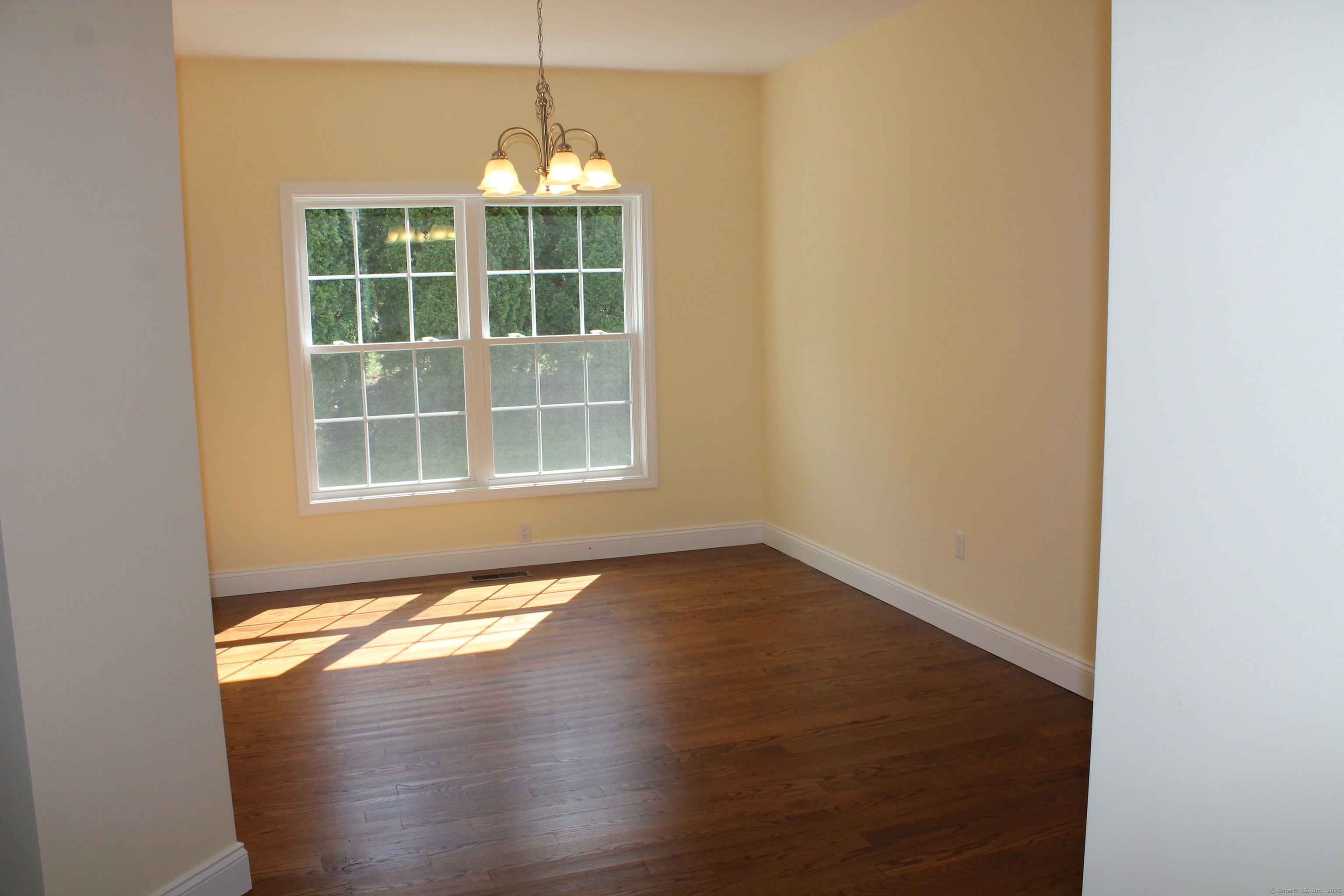 15 Glen Ridge Road Hamden, CT 06518 - Photo 16 of 36 a view of an empty room with wooden floor and a window
