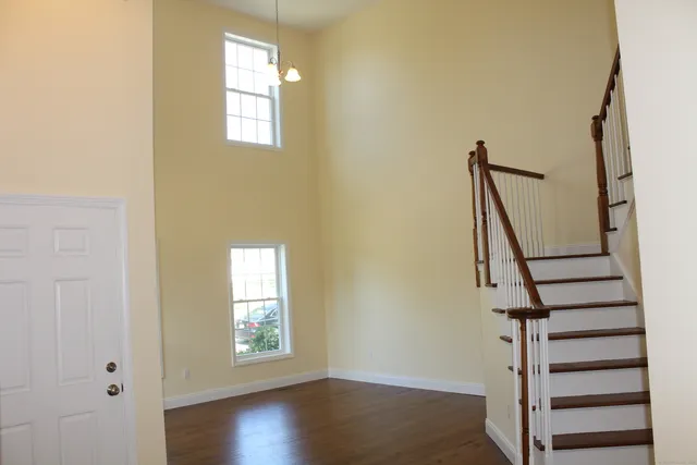 a view of entryway with wooden floor and stairs