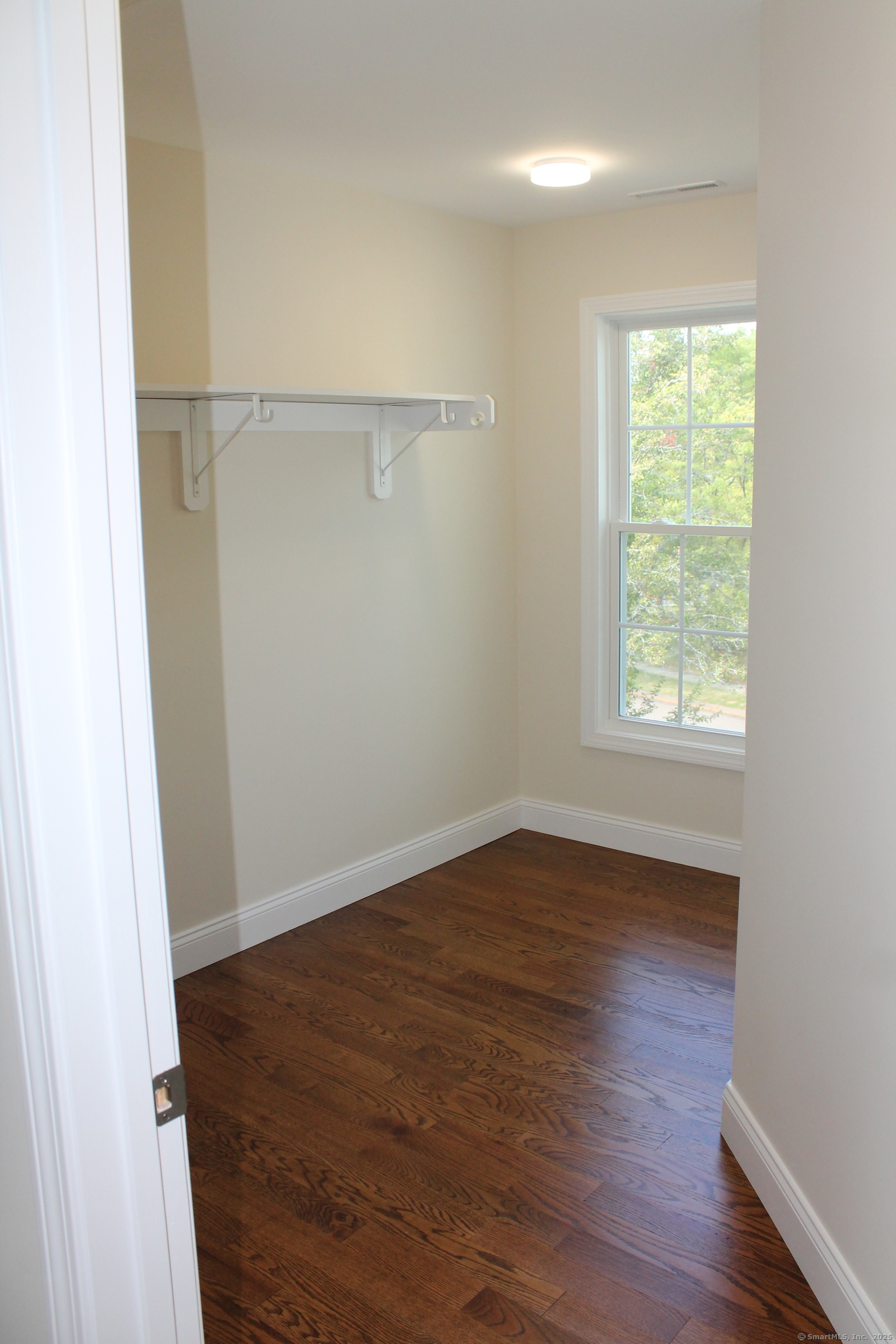 15 Glen Ridge Road Hamden, CT 06518 - Photo 25 of 36 an empty room with wooden floor closet and windows