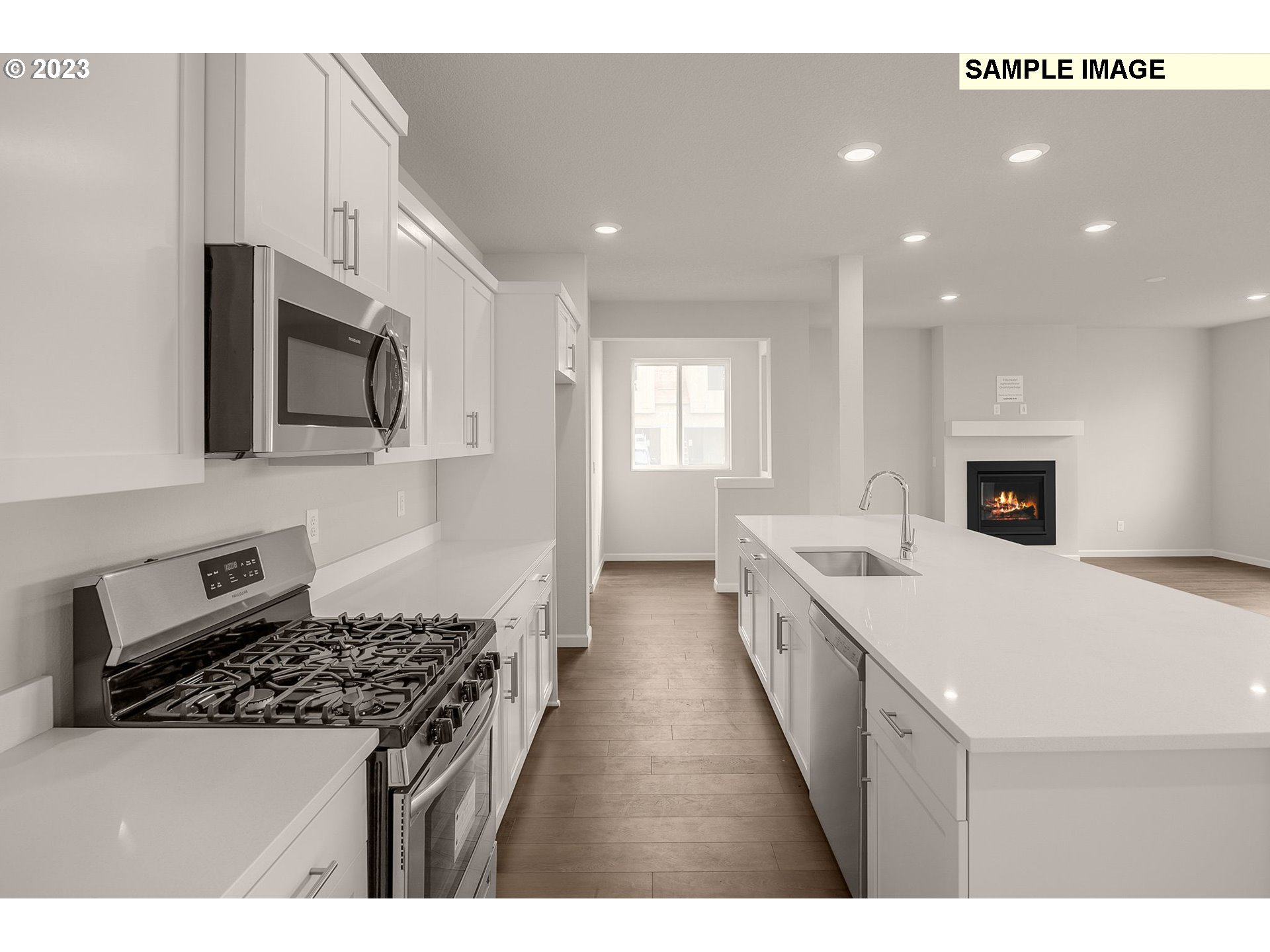 1047 Clemson Street Gervais, OR 97026 - Photo 11 of 38 a large kitchen with stainless steel appliances granite countertop a stove a sink and a microwave