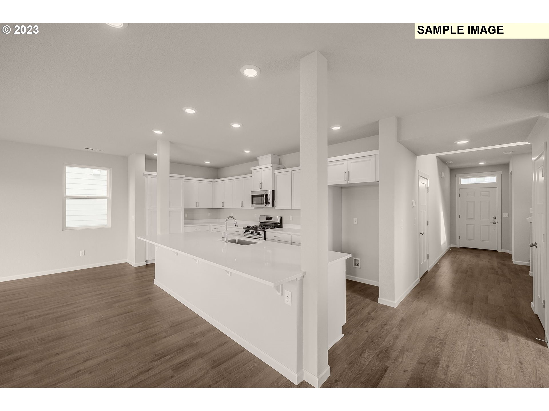 1047 Clemson Street Gervais, OR 97026 - Photo 13 of 38 a view of kitchen with kitchen island white cabinetry and wooden floor