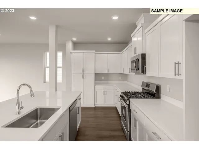 a kitchen with kitchen island a sink stove and cabinets