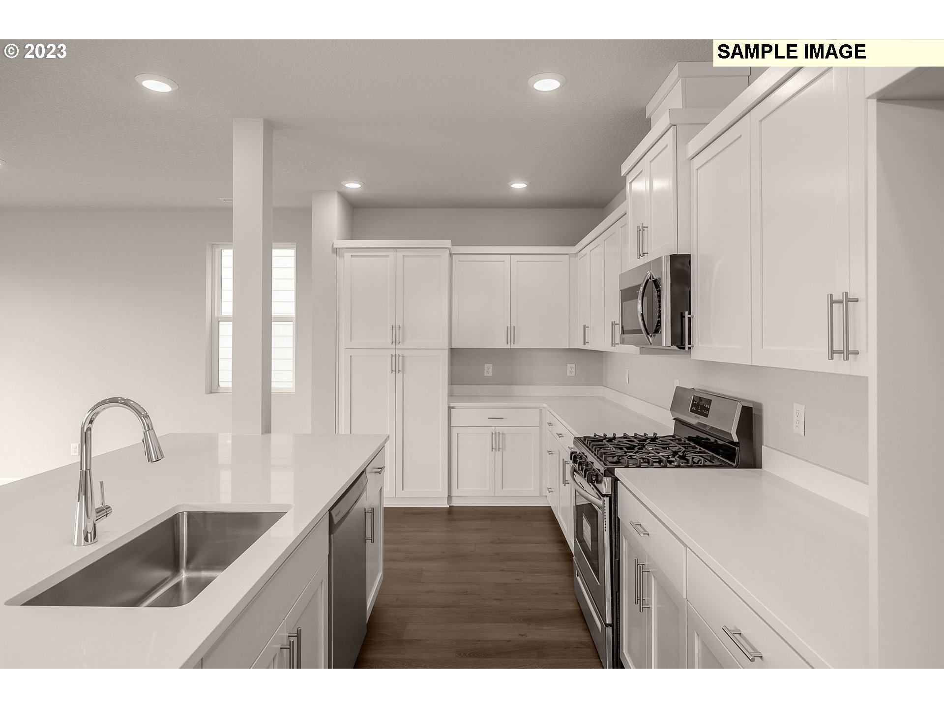 1047 Clemson Street Gervais, OR 97026 - Photo 14 of 38 a kitchen with kitchen island a sink stove and cabinets