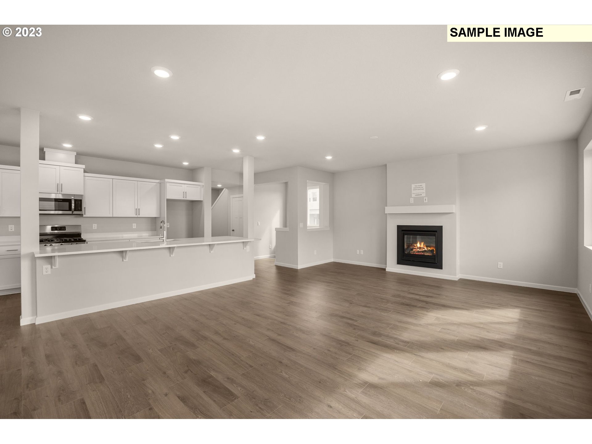 1047 Clemson Street Gervais, OR 97026 - Photo 19 of 38 a view of kitchen with kitchen island granite countertop a stove top oven a sink and a fireplace