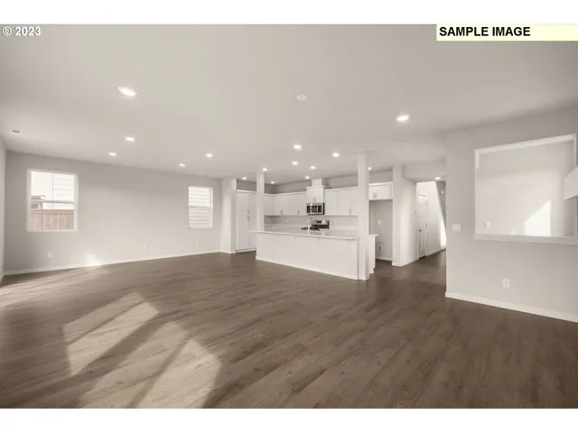 a view of kitchen with refrigerator and window