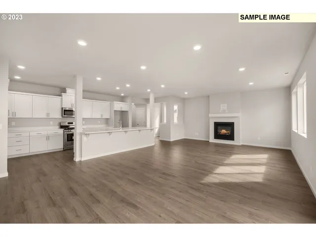 a view of kitchen with kitchen island a sink wooden floor and a stove