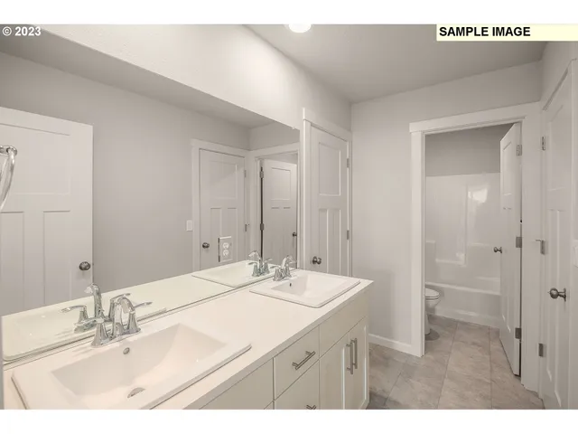 a bathroom with a sink a mirror and a shower