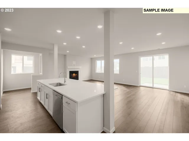 a view of a kitchen with a sink and a large window