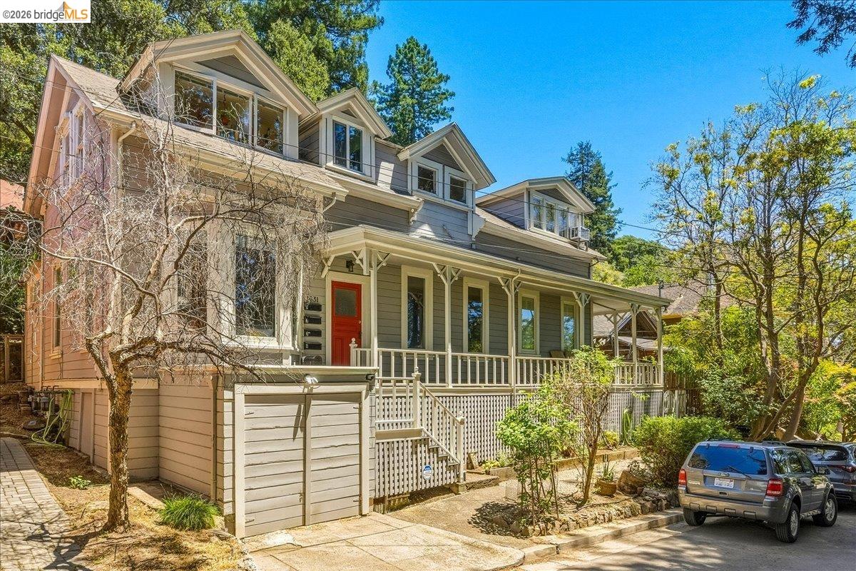 1631 La Vereda Road Berkeley, CA 94709 - Photo 2 of 42 Gray siding exterior featuring a red entry door, white porch railing, and dormer windows