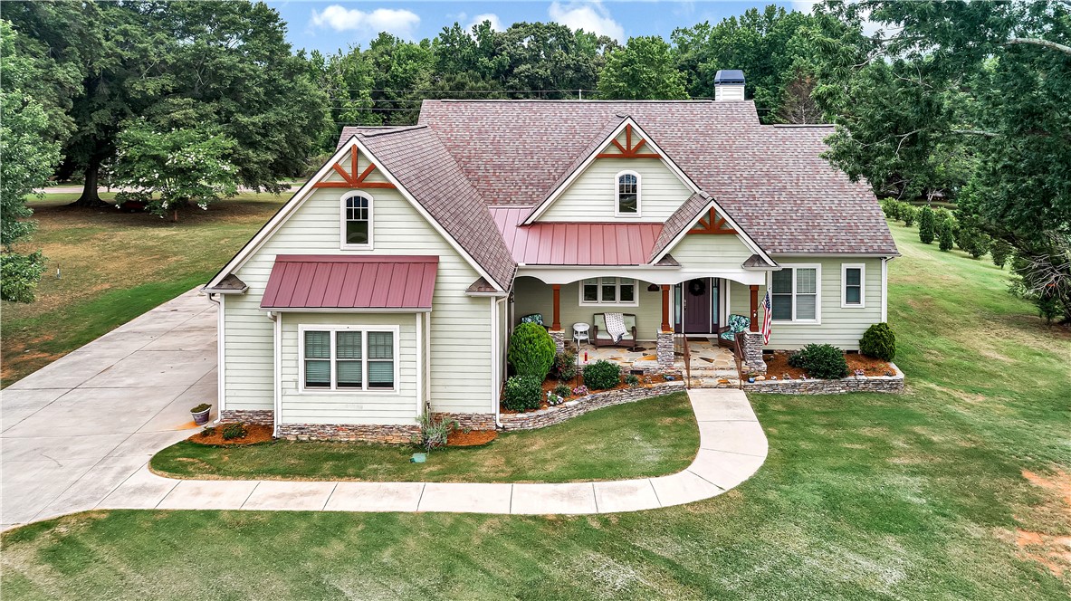 1204 Cherokee Road Townville, SC 29689 - Photo 1 of 44 A charming residence with inviting curb appeal, featuring a wide driveway and meticulously maintained landscaping.