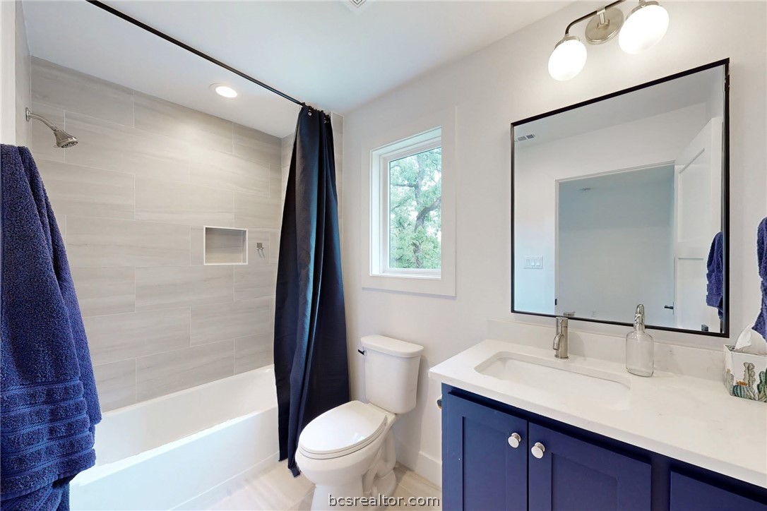 1629 Sawmill Road Franklin, TX 77856 - Photo 32 of 47 a bathroom with a granite countertop sink toilet and shower