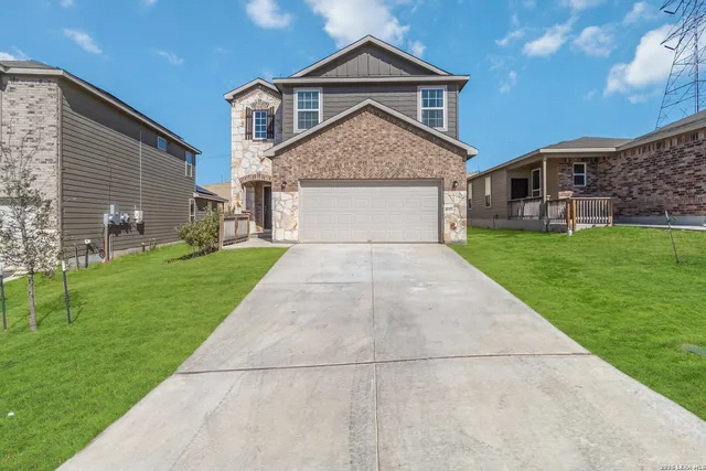 a front view of house with yard and green space