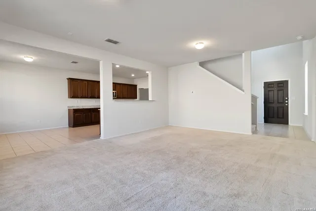 a view of empty room with a fireplace