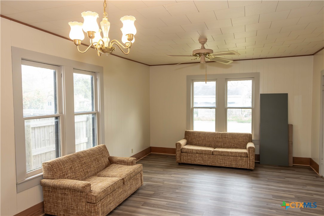 204 Orth Street Yoakum, TX 77995 - Photo 2 of 16 a living room with furniture and a chandelier