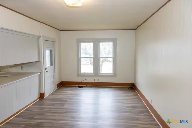 a view of a room with window and wooden floor