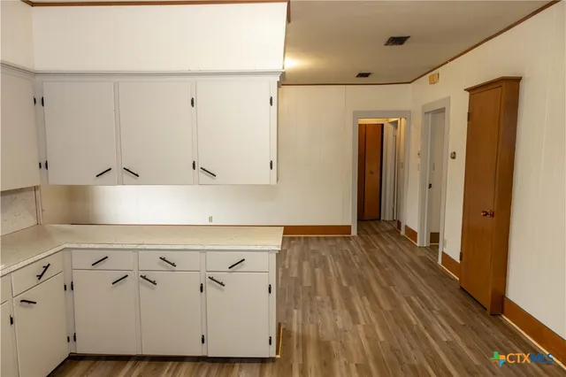 a view of a kitchen with wooden floor