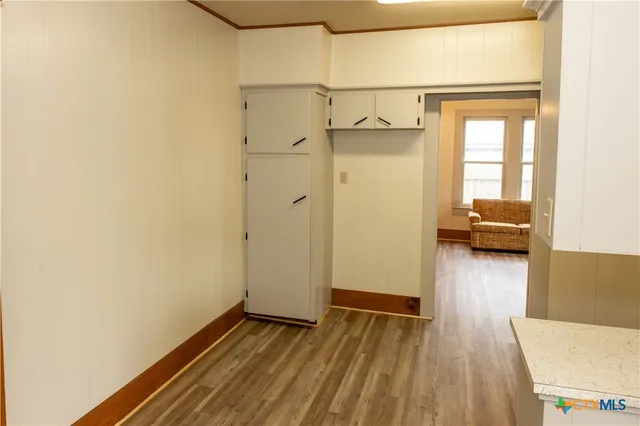 a view of walk in closet with wooden floor