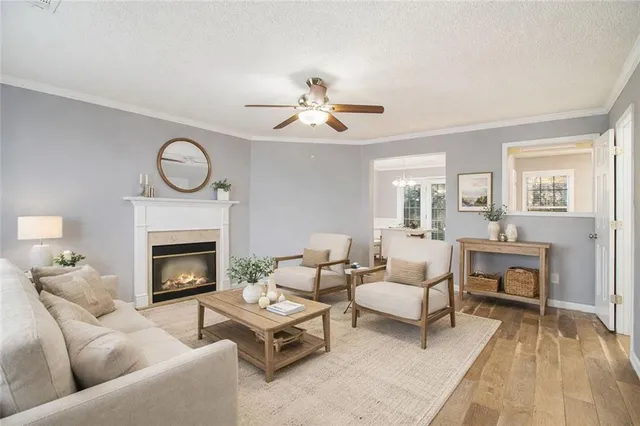 a living room with furniture a fireplace and a table