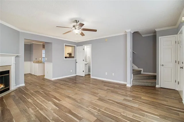 a view of empty room with wooden floor and fireplace