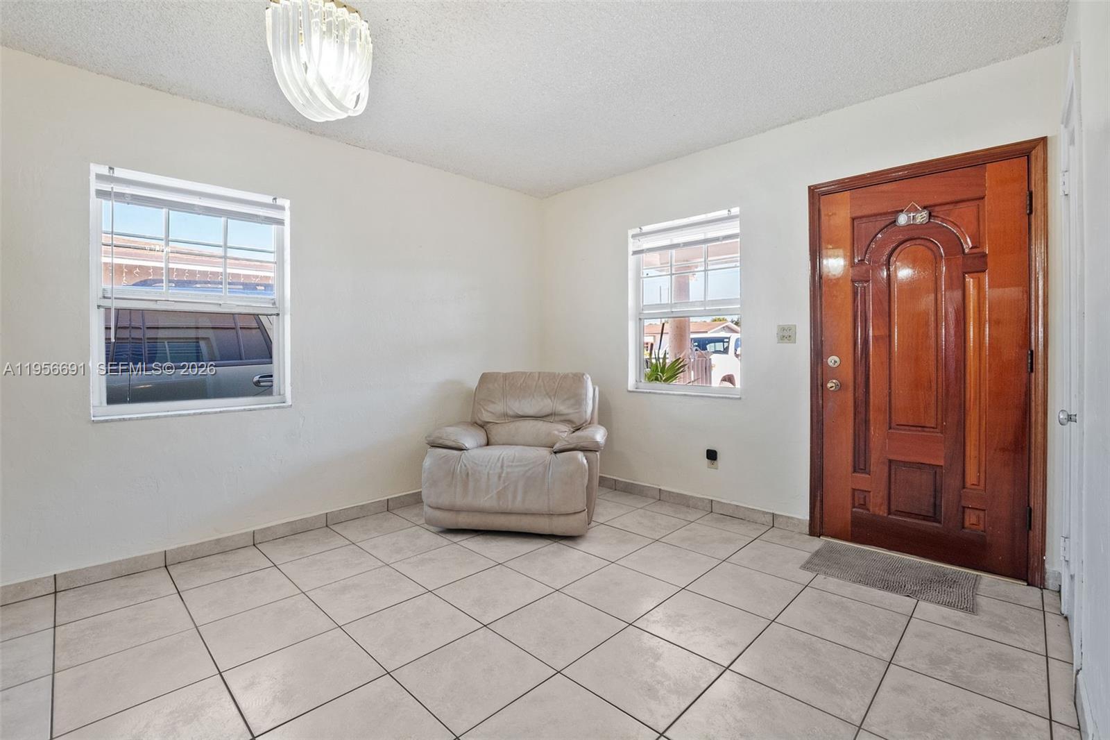 3880 East 8th Lane Hialeah, FL 33013 - Photo 3 of 26 a living room with furniture and a window