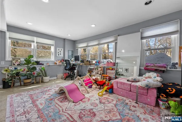 a room with furniture toys and a large window