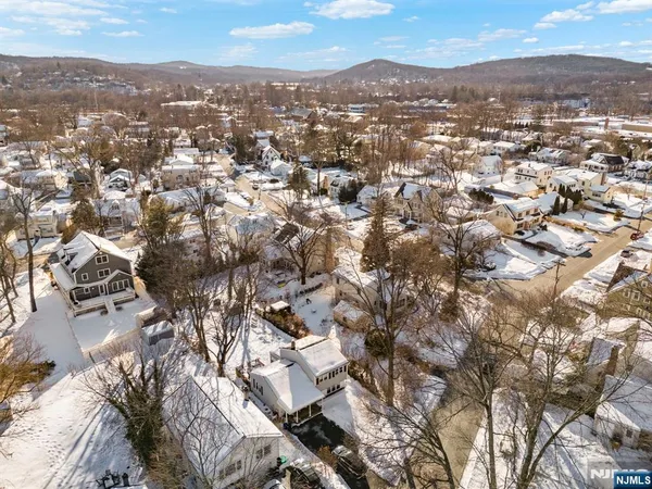an aerial view of residential houses with city view