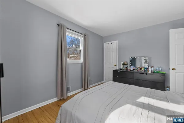 a bed room with a bed and dresser