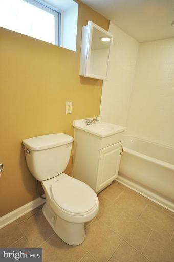 4 Rollwin Road Windsor Mill, MD 21244 - Photo 13 of 24 a white toilet sitting next to a bathroom sink