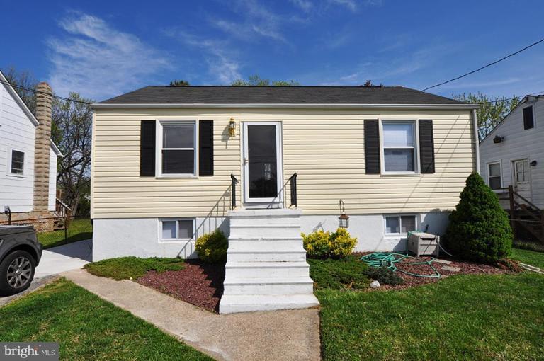 4 Rollwin Road Windsor Mill, MD 21244 - Photo 20 of 24 a front view of a house with a yard and garage