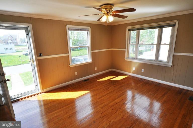 4 Rollwin Road Windsor Mill, MD 21244 - Photo 4 of 24 a view of empty room with wooden floor and fan
