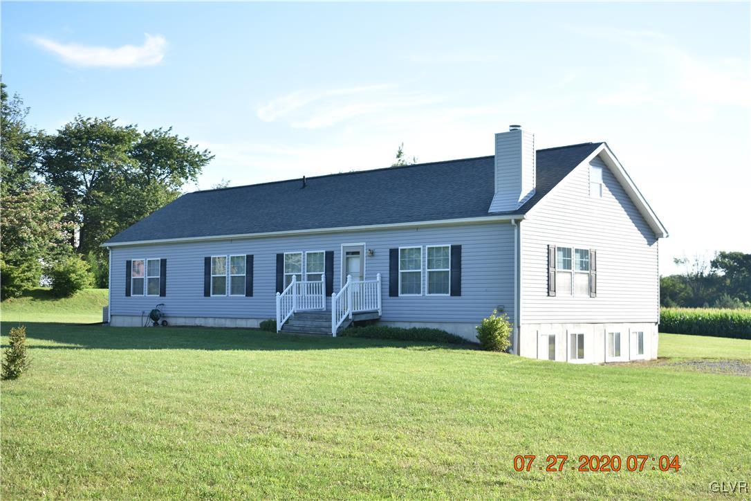 1168 Clearfield Road Nazareth, PA 18064 - Photo 1 of 19 a front view of a house with a yard and trees