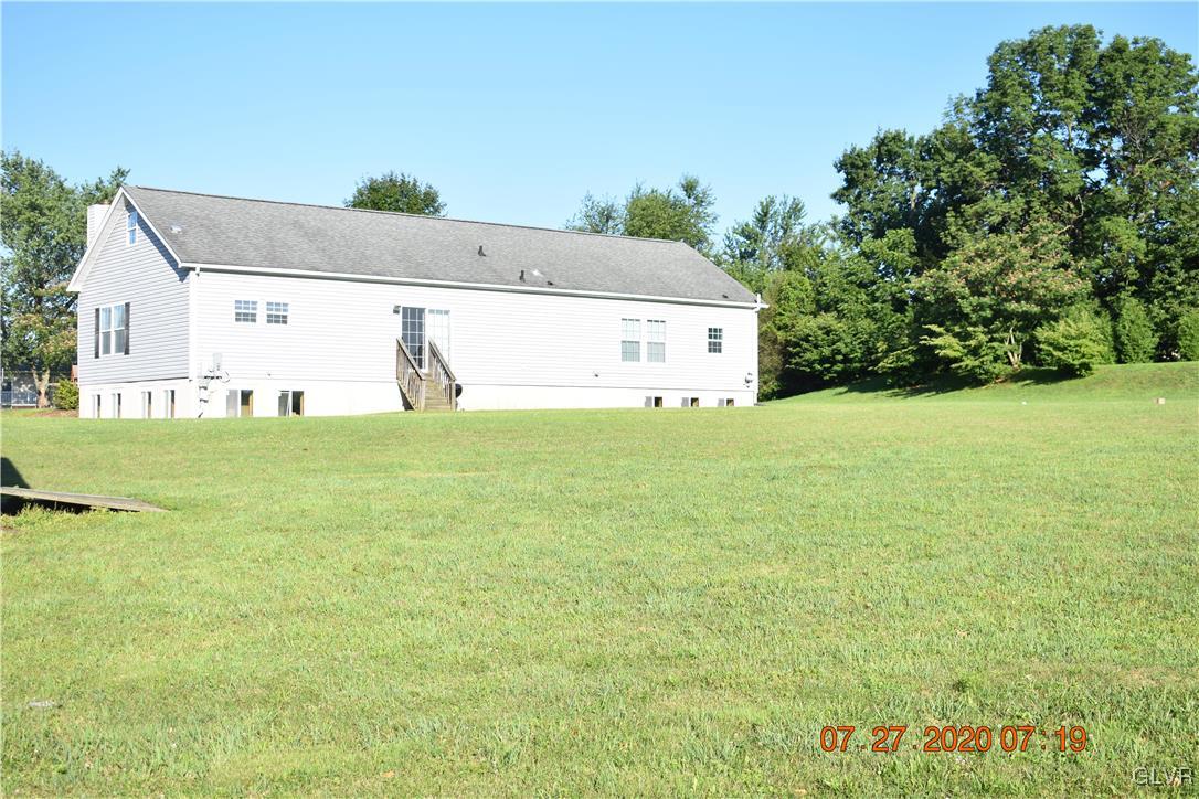1168 Clearfield Road Nazareth, PA 18064 - Photo 19 of 19 a view of a big yard with an tree and wooden fence