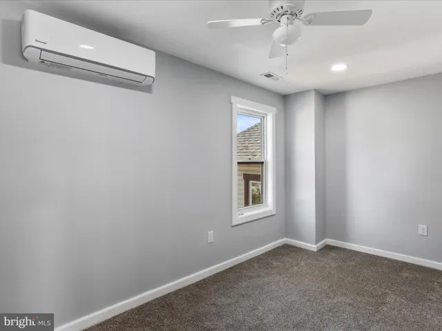 an empty room with windows and closet