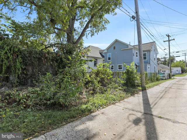 a front view of a house with a yard and tree s