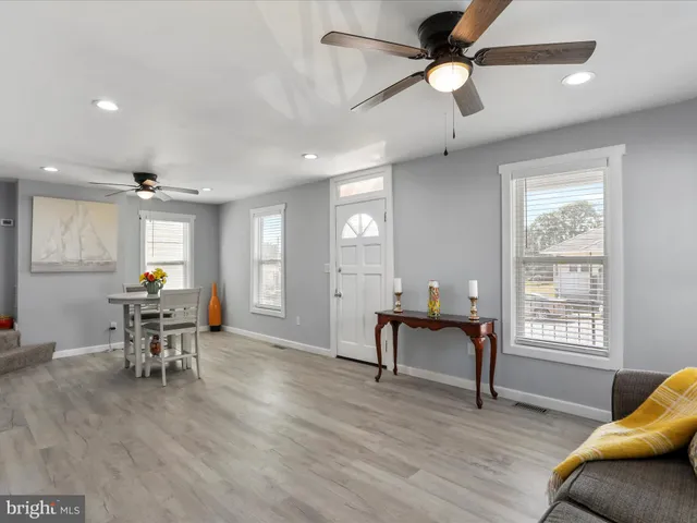 a living room with furniture a window and a piano