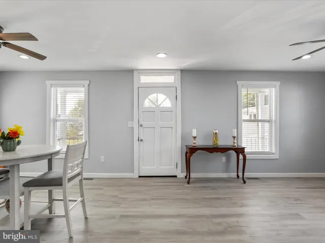 a view of a livingroom with furniture window and wooden floor