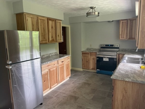 4188 Main Street Palmer, MA 01069 - Photo 8 of 22 a kitchen with stainless steel appliances granite countertop a refrigerator a stove a sink and a refrigerator