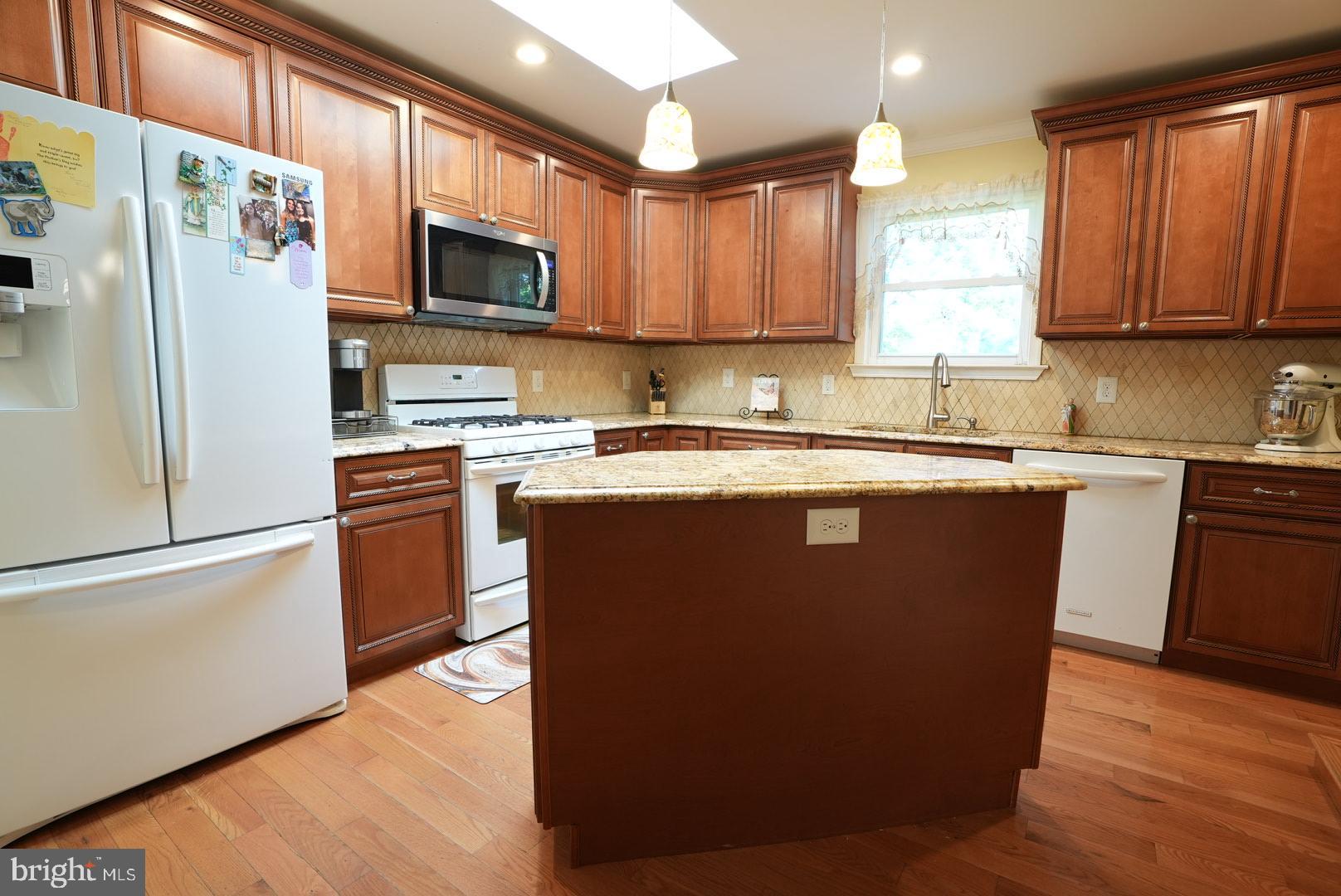 114 Salina Road Sewell, NJ 08080 - Photo 21 of 86 a kitchen with stainless steel appliances granite countertop a refrigerator a sink a stove a microwave and cabinets