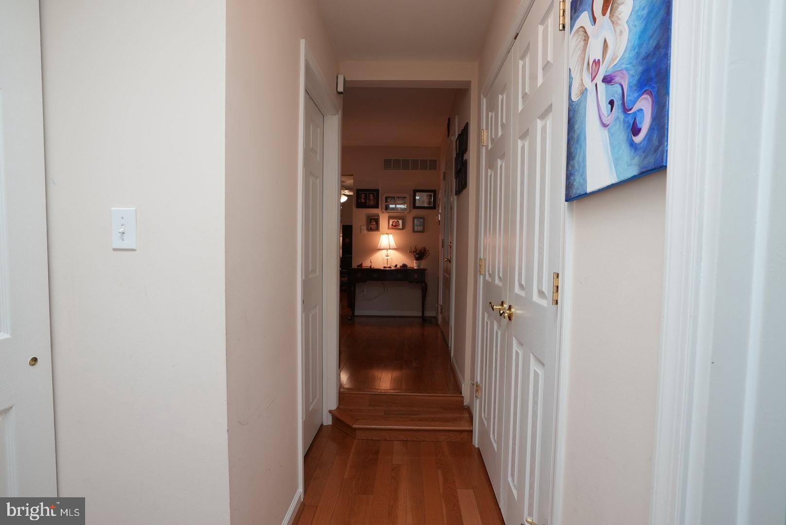 114 Salina Road Sewell, NJ 08080 - Photo 32 of 86 a view of a hallway with wooden floor and a small bathroom