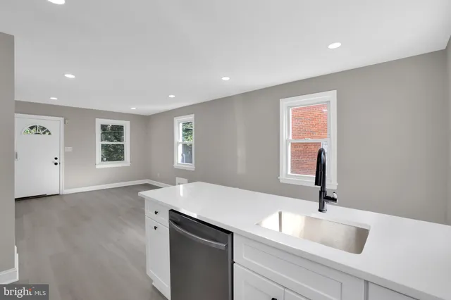 a kitchen with a sink cabinets and wooden floor