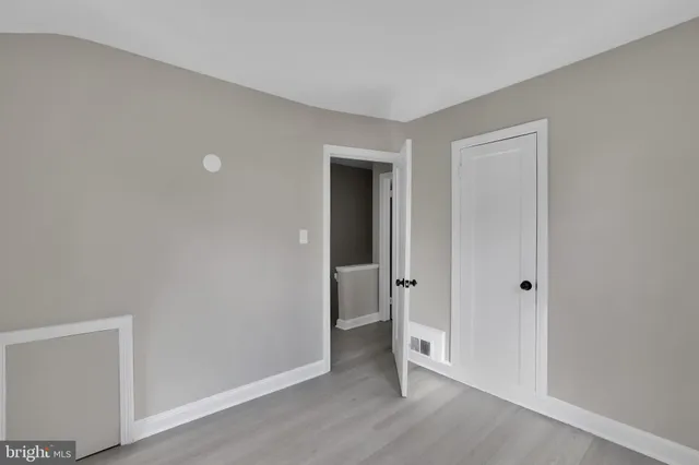 a view of an empty room and closet area