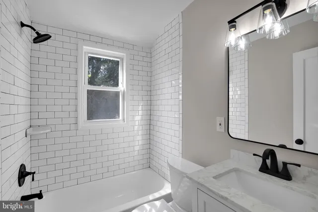 a bathroom with a sink a bathtub and a shower