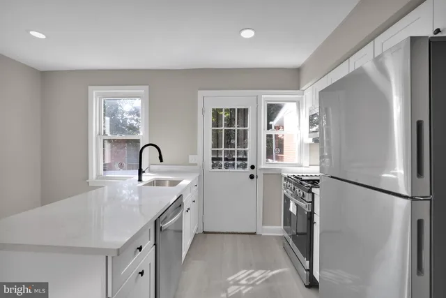 a kitchen with refrigerator and window