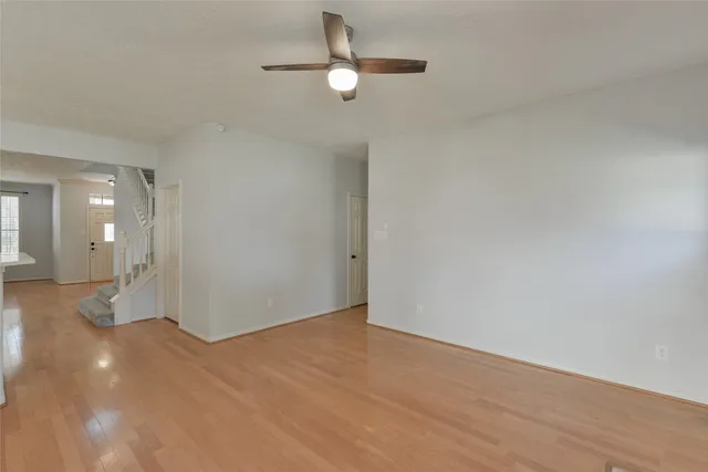 a view of empty room with ceiling fan