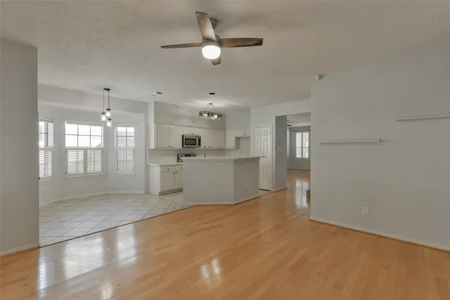 a view of a kitchen with a sink and a refrigerator