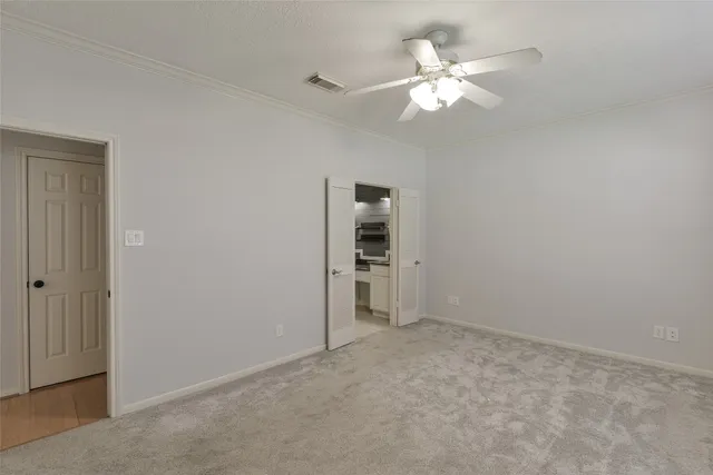 a view of an empty room with a ceiling fan